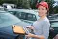 Woman car mechanician repairs engine car and smiles
