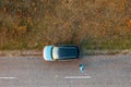 Woman and car on road through grassy wastelands, aerial view Royalty Free Stock Photo