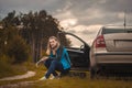 Woman on a car struck a wheel on the picturesque road