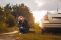 Woman on a car struck a wheel on the picturesque road