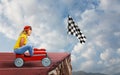 Woman on the car thinks she has won but there is a precipe after the finishline Royalty Free Stock Photo