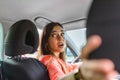 Woman in car turning around looking at passengers in back seat idea taxi driver. Concept of exam Vehicle. Back view of an Royalty Free Stock Photo