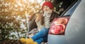 Woman in a car in warm socks is holding a Cup of coffee in hands. Cozy autumn weekend trip. Freedom of travel Royalty Free Stock Photo