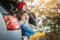 Woman in a car in warm socks is holding a Cup of coffee in hands. Cozy autumn weekend trip. Freedom of travel Royalty Free Stock Photo