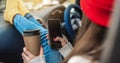 Woman in a car in warm socks is holding a mobile phone gadget. Cozy autumn weekend trip. Freedom of travel Royalty Free Stock Photo