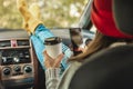 Woman in a car in warm socks is holding a mobile phone gadget. Cozy autumn weekend trip. Freedom of travel Royalty Free Stock Photo