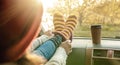 Woman in a car in warm woolen yellow socks on the car dashboard. Cozy autumn weekend trip. Concept of freedom of travel Royalty Free Stock Photo