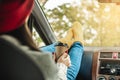 Woman in a car in warm yellow socks is holding a Cup of coffee in hands. Cozy autumn weekend trip. Freedom of travel Royalty Free Stock Photo