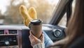 Woman in a car in warm yellow socks is holding a Cup of coffee in hands. Cozy autumn weekend trip. Freedom of travel Royalty Free Stock Photo