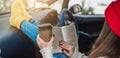 Woman in a car in warm yellow socks is reading a book while sitting in the passenger seat. Cozy autumn weekend trip Royalty Free Stock Photo