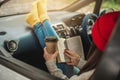 Woman in a car in warm yellow socks is reading a book while sitting in the passenger seat. Cozy autumn weekend trip Royalty Free Stock Photo