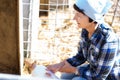 Woman care feeds two week old calf from bottle with dummy Royalty Free Stock Photo