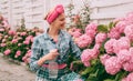 Woman care of flowers in garden. happy woman gardener with flowers. hydrangea. Spring and summer. Greenhouse flowers