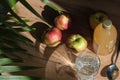 woman carefully pours apple cider vinegar into a spoon, adding it to a glass of water to create a healthy, invigorating