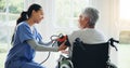 Woman, caregiver and senior in wheelchair for blood pressure, monitoring or elderly care at old age home. Nurse or