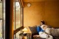 Woman with her dog in wooden house on nature Royalty Free Stock Photo