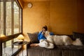 Woman with her dog in wooden house on nature Royalty Free Stock Photo