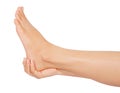Woman cares about her feet on white background with clipping path