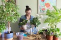 Woman caring for potted plants, replanting, fertilizing.