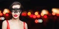 Woman in carnival mask on black night background with abstract bokeh glitter Royalty Free Stock Photo