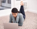 Woman on carpet with laptop, search and relax with studying, college research and browse on web in living room