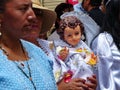 Woman carries baby Jesus doll, Ecuador