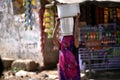 Woman carries buckets of water