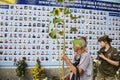 Woman carries flowers to Memory Wall of Fallen Defenders of Ukraine in war in Eastern Ukraine 2014-2020. Kyiv, Ukraine