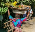 Woman carries goods on head along rural streets of Haiti