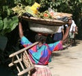 Haitian woman carries goods along the road.