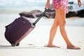 Woman carries your luggage at sandy beach Royalty Free Stock Photo