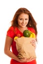 Woman carrying a bag full of various fruits isolated over white Royalty Free Stock Photo