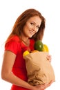 Woman carrying a bag full of various fruits isolated over white Royalty Free Stock Photo