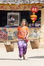 Woman carrying baskets in the Kuomintang CHinese village of Mae Aw or Baan Rak Thai, Mae Hong Son, Thailand