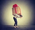 Woman carrying big present on her back Royalty Free Stock Photo