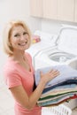 Woman Carrying Folded Up Laundry Royalty Free Stock Photo