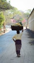 A woman carrying goods on head in Bagan, Myanmar Royalty Free Stock Photo