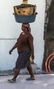 A woman carrying goods on head strolls along the streets of Port-au-Prince, Haiti.