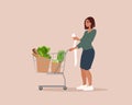 Woman is carrying a grocery cart full of groceries Royalty Free Stock Photo