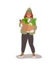 Woman holding a paper bag full of vegetables Royalty Free Stock Photo