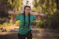 Woman carrying heavy wooden log during obstacle course Royalty Free Stock Photo