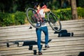 Woman carrying a mountain bike