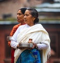 Woman carrying offerings Nepal