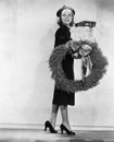 Woman carrying packages and Christmas wreath