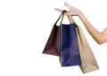 Woman carrying paper shopping bags isolated on white background. Adult woman hand hold three shopping bag with blue and brown Royalty Free Stock Photo