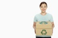Woman carrying a stack of recyclable cardboard boxes Royalty Free Stock Photo