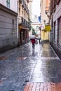 People in Madrid during a rainy day