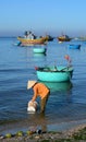 Woman carrying water at seashore in Nhatrang