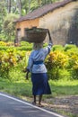 Woman carrying weight in Goa, India