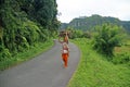 WOMAN CARRYING WOOD IN INDONESIA